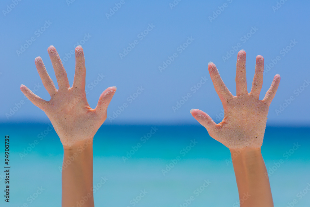Female open hand on blue sea background