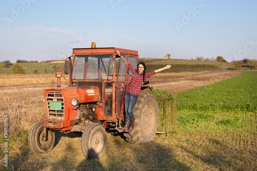 Girl in the tractor on farmland