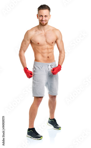 Athletic attractive man wearing boxing bandages on the white
