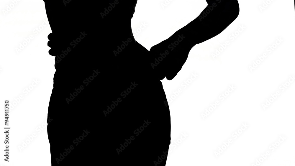 Slim, sporty girl in big jeans, showing her lose weight, on white, silhouette Slim, sporty girl in big jeans, showing her lose weight, on white, silhouette