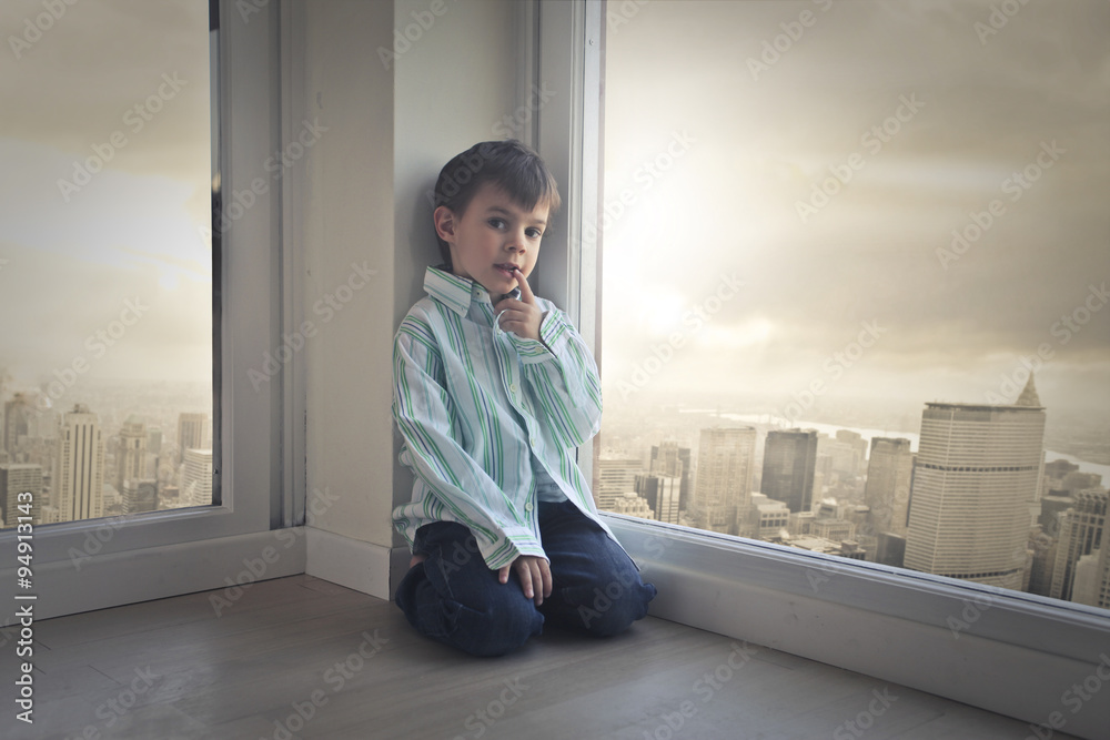 Young child sitting in the corner of a room Stock Photo | Adobe Stock