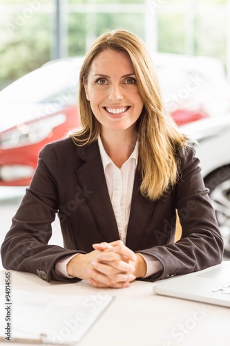 Smiling saleswoman working at her desk Free Download Smiling saleswoman working at her desk - GFXLoad