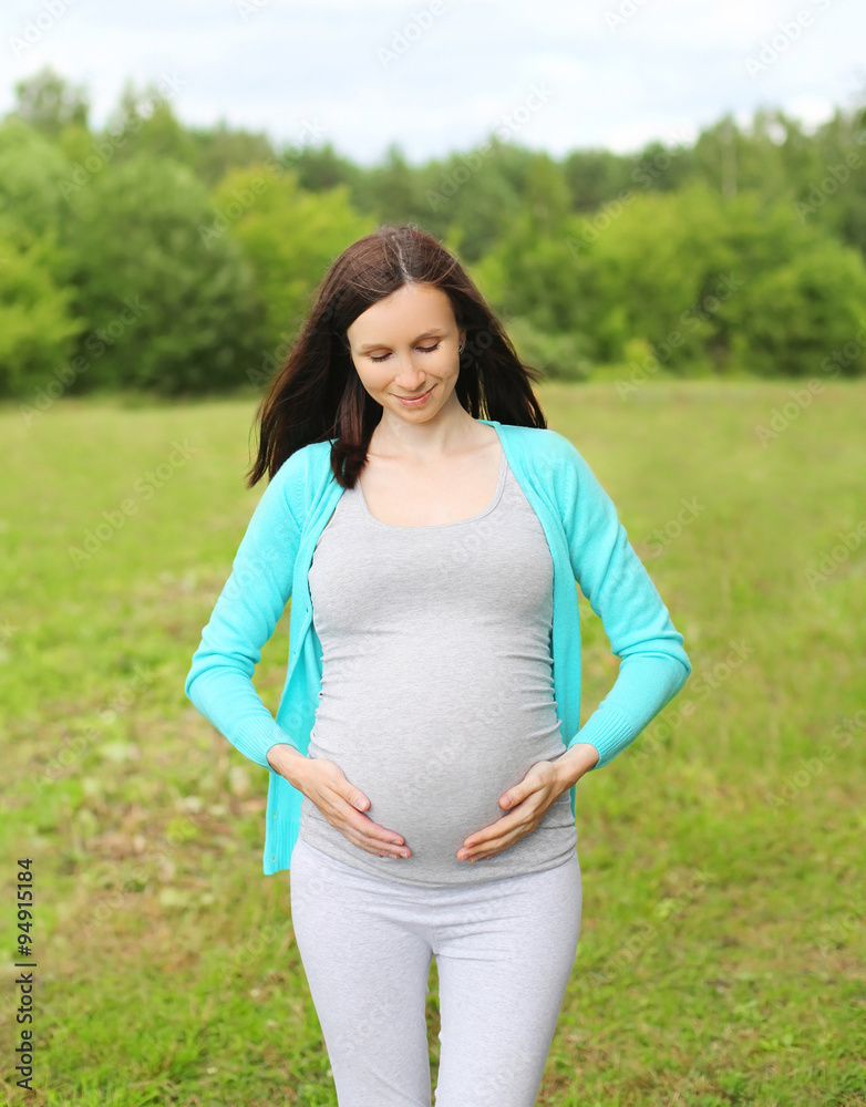Portrait smiling pregnant woman outdoors in summer day Portrait smiling pregnant woman outdoors in summer day