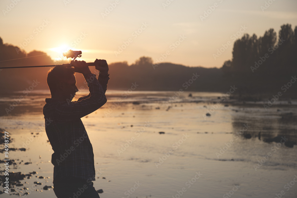 the fisherman is fishing on a river in the early morning. the fisherman is fishing on a river in the early morning.