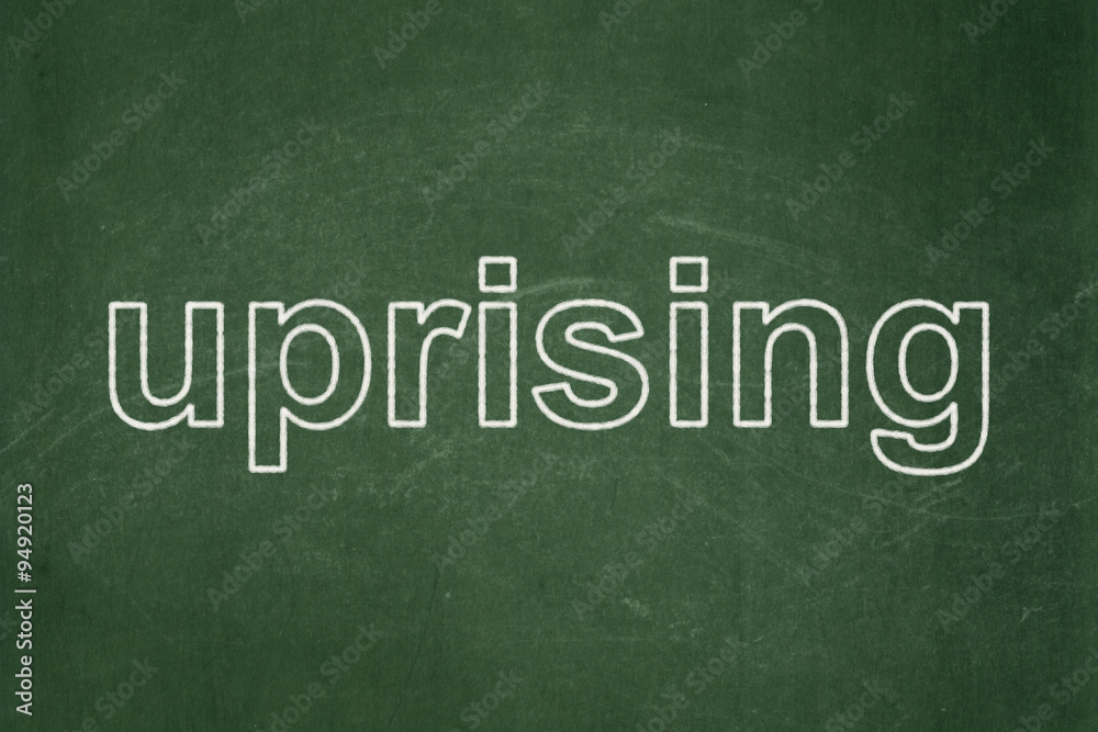 Political concept: Uprising on chalkboard background Political concept: Uprising on chalkboard background