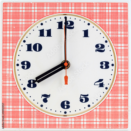 Round clock face on red striped background