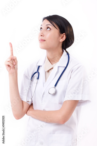 smart female doctor pointing up to blank space