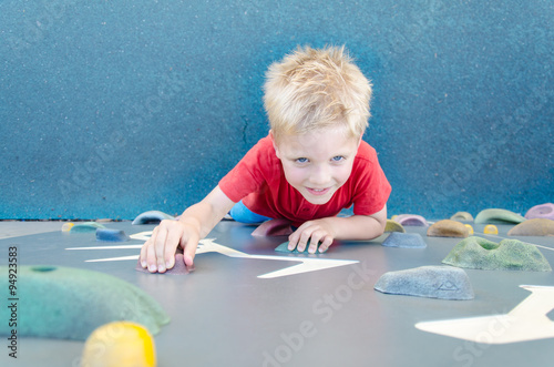 Child on a climbing wall in a park