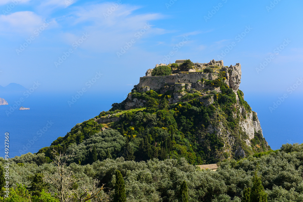 Distant view at Angelokastro castle with Paleokastratsa on background, Corfu, Greece.