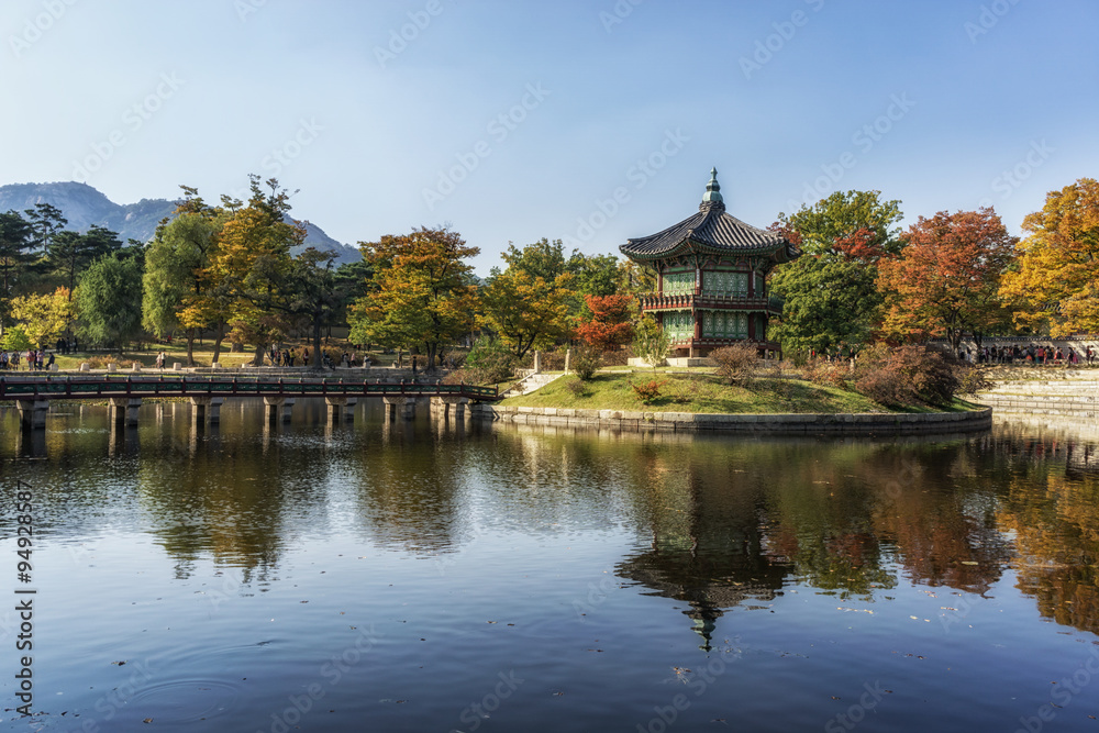 hyangwonjeong autumn reflections and fall colors with lake reflections of the leaves surrounding the pavilion. Taken in Gyeongbokgung, South Korea. 