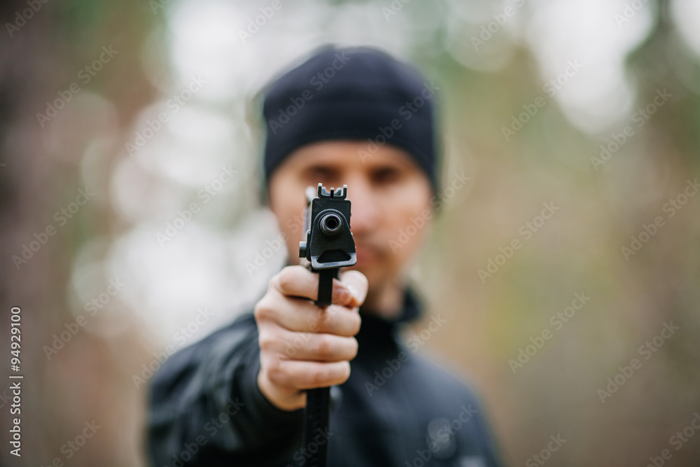 man with gun on a outdoor background man with gun on a outdoor background