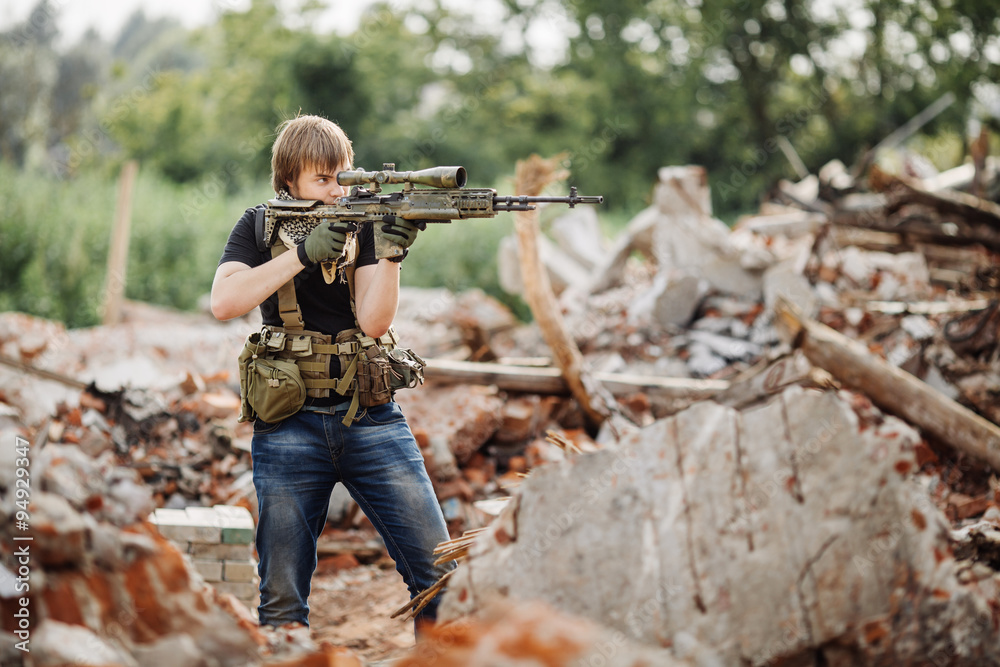 Fototapeta premium Private Military Contractor on patrol in destroyed city