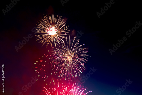 Colorful fireworks over dark sky, displayed during a celebration
