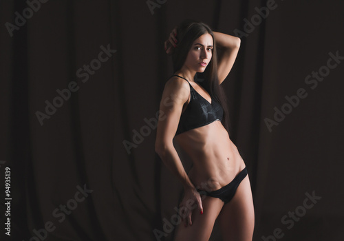 Fitness girl on dark background.
