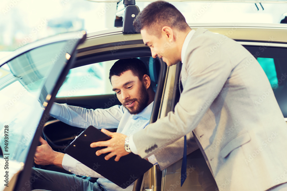 happy man with car dealer in auto show or salon happy man with car dealer in auto show or salon