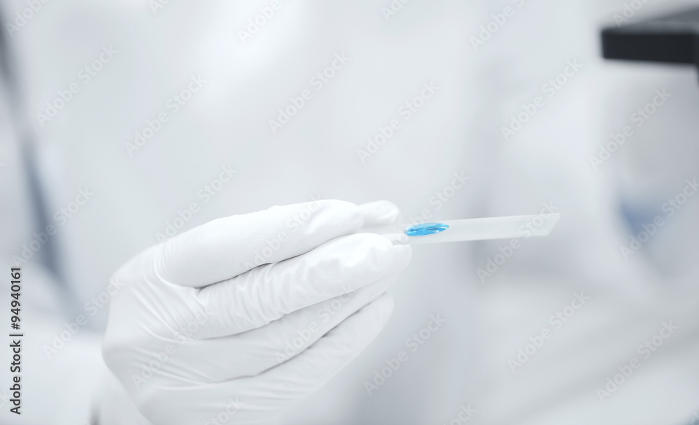 close up of scientist hand with test sample in lab close up of scientist hand with test sample in lab