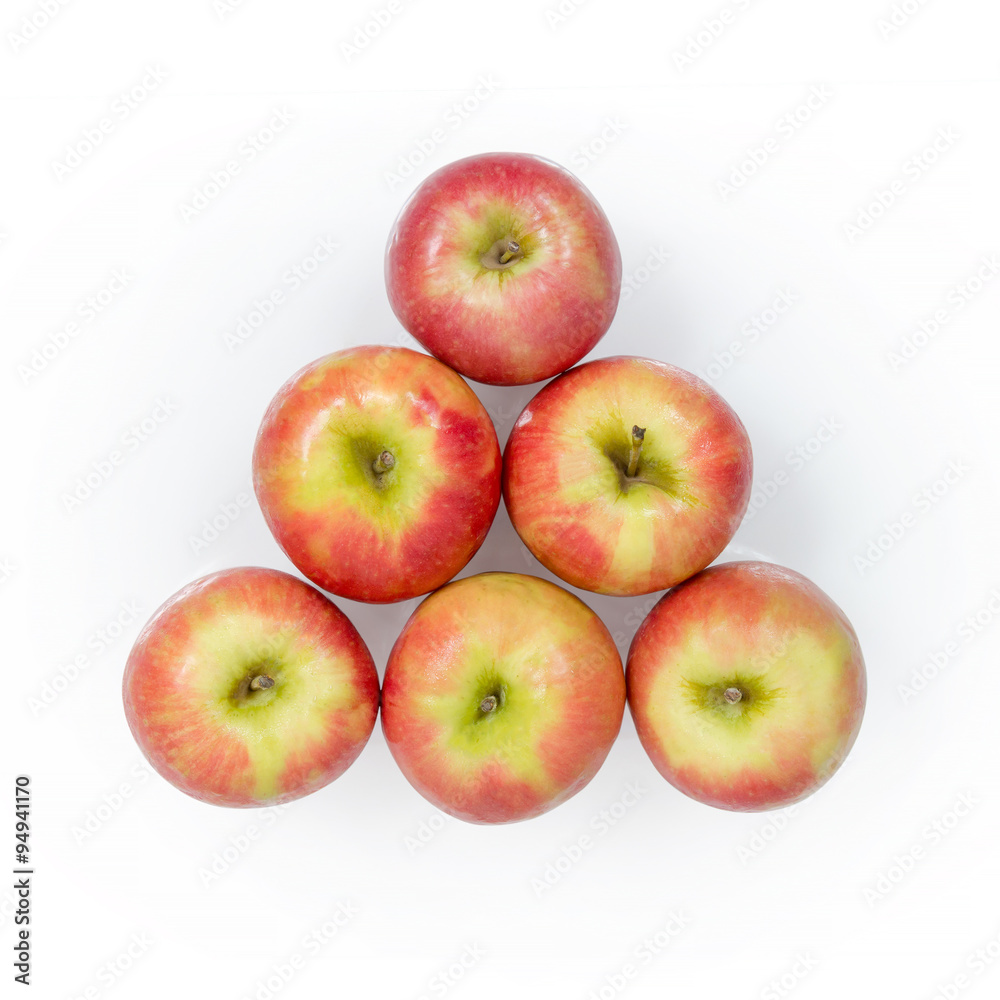 Apples arranged in a shape of triangle on white background Apples arranged in a shape of triangle on white background