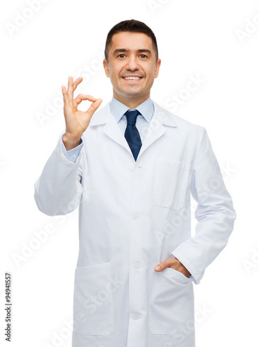 smiling doctor in white coat showing ok hand sign