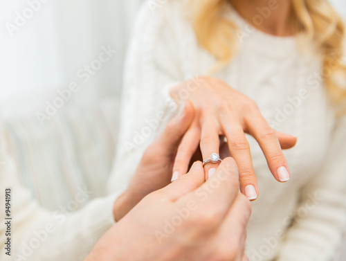 close up of man giving diamond ring to woman