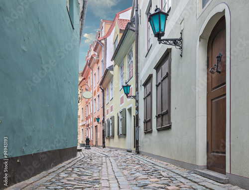 Medieval street in old Riga city. Riga is the capital and largest city of Latvia, a major commercial, financial, cultural, historical and tourist center of the Baltic region. 