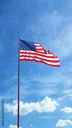 American Flag flying against blue sky