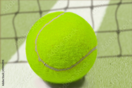  tennis ball placed on white border line inside of tenis court © jakrin1976