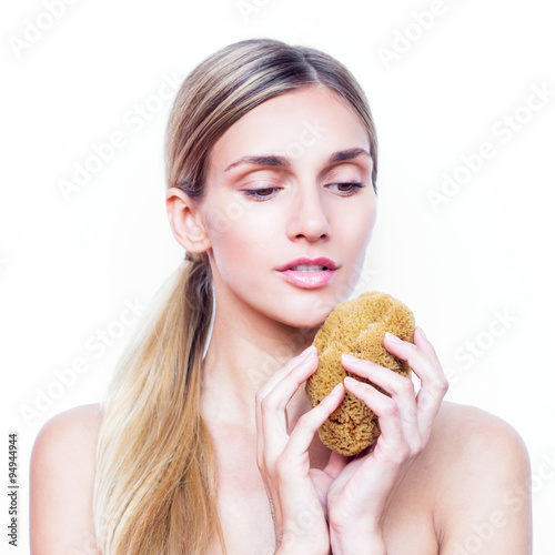 Beautiful young woman with a natural sponge