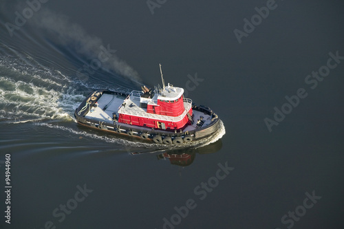 A aerial view of a bright red tug boat outside of Portland Maine photo