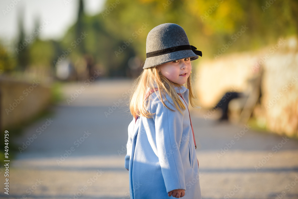 Autumn walk a little blond girl