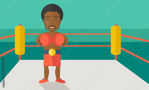 Boxer in gloves standing in ring.