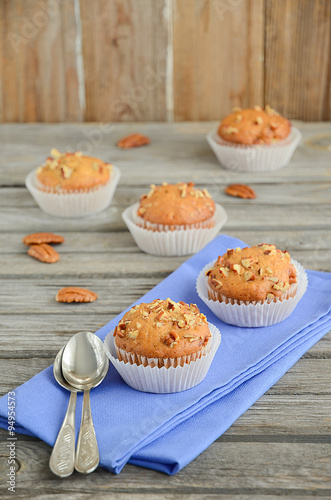 Homemade banana muffins with pecans on the wooden table