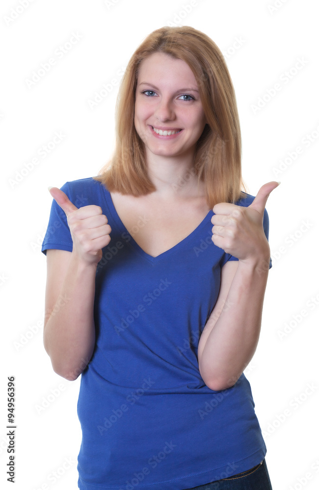 Fototapeta premium Junge Frau mit rötlichen Haaren zeigt beide Daumen