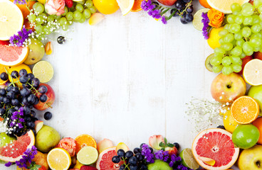 Fruits, berries , flowers frame, white wooden background. Copy space.