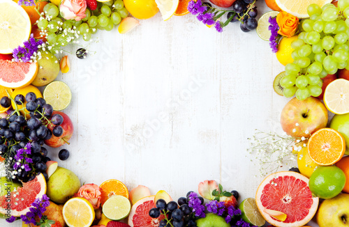 Fruits, berries , flowers frame, white wooden background. Copy space.