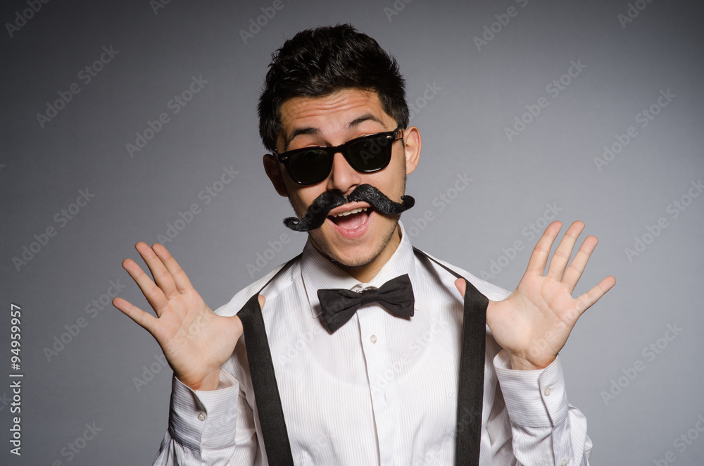 Obraz premium Young man in black sunglasses isolated on gray