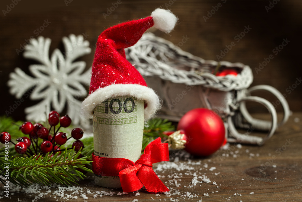 Gift money with red ribbon and Santa cap