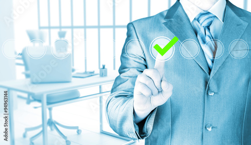 business man touching, pressing modern button with green ticking Check Box