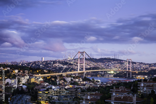 Twilight view of Bosphorus Bridge which is one of two suspension bridges spanning the Bosphorus strait in Istanbul Turkey