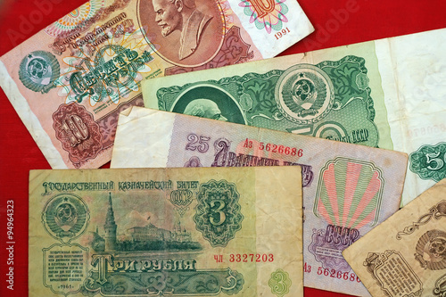 Old Soviet Russian banknotes: 1, 3, 10, 25, 50 rubles on a red b photo