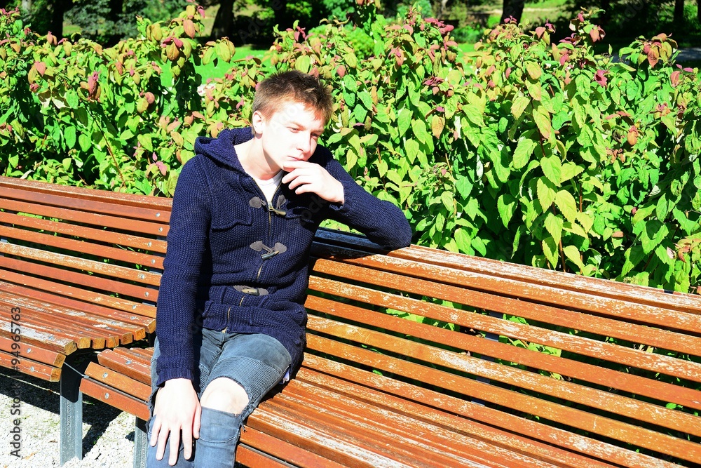 Young man in Vilnius town Bernardinu garden on autumn