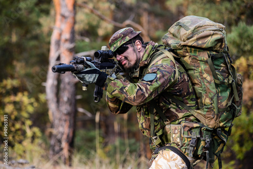 Photos Armed man with military backpack/Young man in military uniform and sunglasses ho
