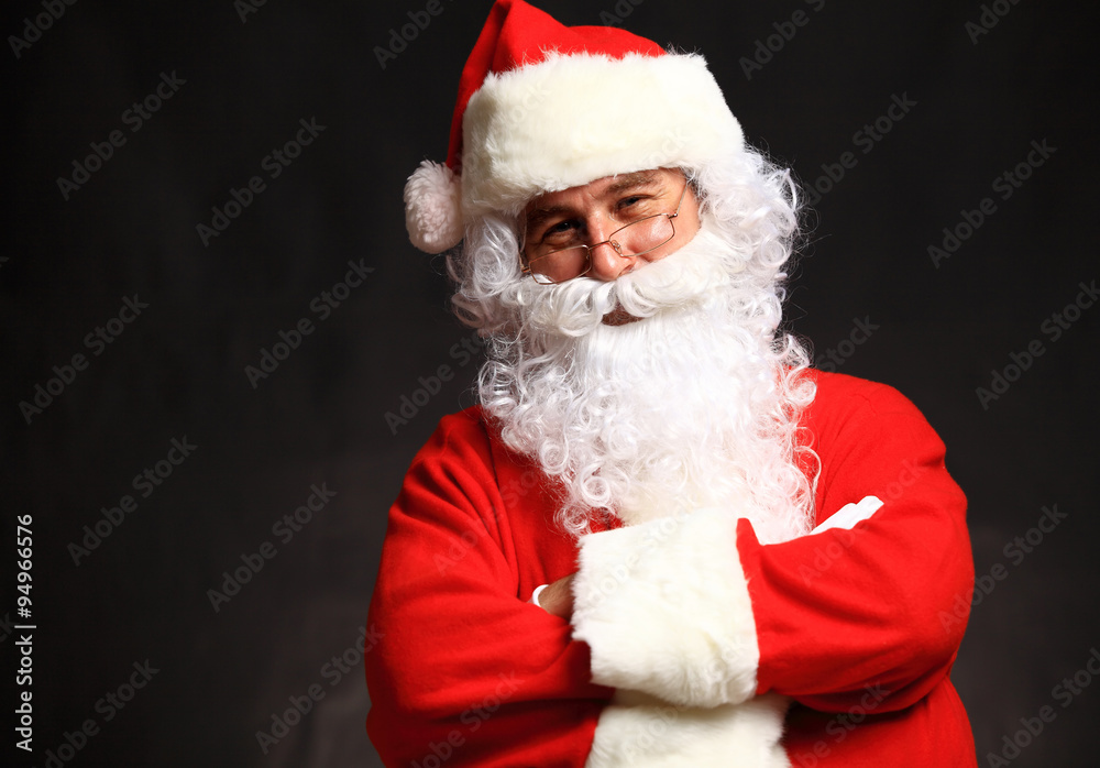 Photo of happy Santa Claus in eyeglasses looking at camera Photo of happy Santa Claus in eyeglasses looking at camera