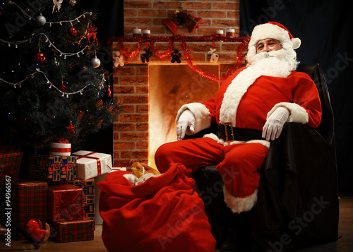 Santa Claus having a rest in a comfortable chair 