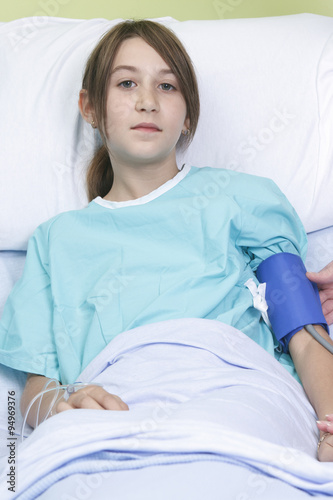 Little girl in hospital bed with the nurse