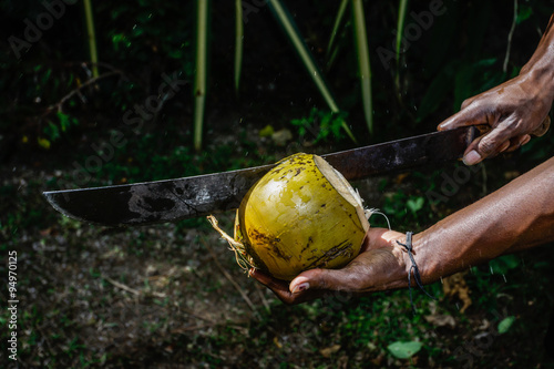 Man chopping a coconut