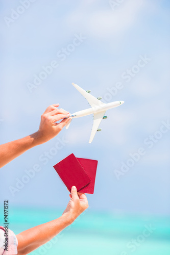 Closeup of passports and white airplane background the sea