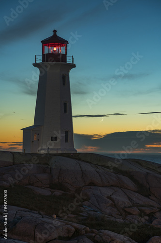 Lighthouse at Peggy s Point  Nova Scotia  with crescent moon.