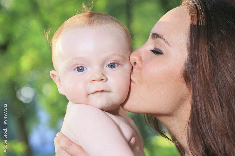 A mother with is baby on a beautiful forest A mother with is baby on a beautiful forest