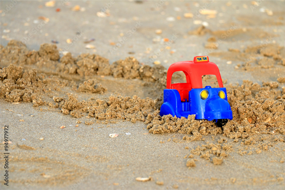 Tuk tuk, Plastic toy on the beach. Tuk tuk, Plastic toy on the beach.