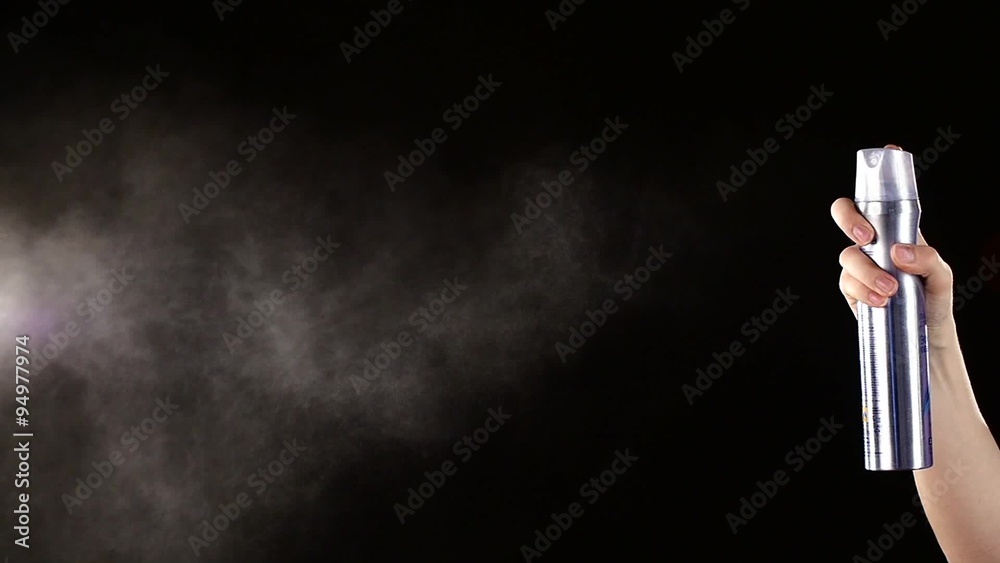 Spray bottle drops for hairstyle on black, slow motion